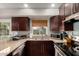 Kitchen with wood cabinets, stainless steel appliances, and a window overlooking the backyard at 19414 N 3Rd Ave, Phoenix, AZ 85027