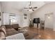 Spacious living room featuring a plush sectional sofa, vaulted ceiling, and hardwood floors at 19414 N 3Rd Ave, Phoenix, AZ 85027