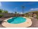 Sparkling swimming pool surrounded by lush greenery, desert plants and a covered patio at 19414 N 3Rd Ave, Phoenix, AZ 85027
