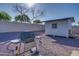 An outdoor BBQ grill with an adjacent storage building in a low-maintenance gravel backyard at 19849 N 33Rd Ave, Phoenix, AZ 85027