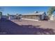 A sprawling gravel backyard showcases an enclosed patio with a small outbuilding and block fence at 19849 N 33Rd Ave, Phoenix, AZ 85027