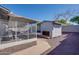 The backyard features a walkway leading to the enclosed patio and a small backyard building structure at 19849 N 33Rd Ave, Phoenix, AZ 85027