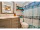Stylish bathroom with a modern vanity, decorative shelves, and a shower-tub combo at 19849 N 33Rd Ave, Phoenix, AZ 85027