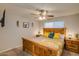 This bedroom features a wooden bed frame, ceiling fan, and light colored walls at 19849 N 33Rd Ave, Phoenix, AZ 85027