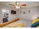 This bedroom features a wooden bed frame, television, and doorway to the bathroom at 19849 N 33Rd Ave, Phoenix, AZ 85027