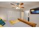This bedroom features a wooden bed frame, ceiling fan, and doorway to the bathroom at 19849 N 33Rd Ave, Phoenix, AZ 85027