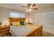This bedroom features a wooden bed frame, ceiling fan, and mirrored closet at 19849 N 33Rd Ave, Phoenix, AZ 85027