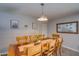 Dining area with a wooden table, stylish decor, and neutral colored walls and flooring at 19849 N 33Rd Ave, Phoenix, AZ 85027