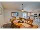 Open dining area with wooden table, view to kitchen and sliding glass doors to the patio at 19849 N 33Rd Ave, Phoenix, AZ 85027