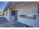 Charming entrance features a security door and awning over a front window, enhancing curb appeal at 19849 N 33Rd Ave, Phoenix, AZ 85027