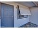 Cozy covered porch features a gray front door, gray window, and desert landscaping details at 19849 N 33Rd Ave, Phoenix, AZ 85027