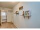 A hallway with a view of the kitchen area with shelving for board games to organize the space at 19849 N 33Rd Ave, Phoenix, AZ 85027