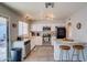 Well-lit kitchen featuring white cabinets, stainless steel appliances, and a breakfast bar with seating at 19849 N 33Rd Ave, Phoenix, AZ 85027
