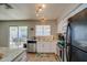 Kitchen with stainless steel appliances, granite counters, eat-in bar and sliding glass door to the patio at 19849 N 33Rd Ave, Phoenix, AZ 85027