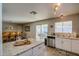 Bright kitchen with sliding glass door leading to the back patio and an eat-in breakfast bar at 19849 N 33Rd Ave, Phoenix, AZ 85027
