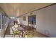 Long, enclosed patio featuring an outdoor dining space, foosball table, and backyard views at 19849 N 33Rd Ave, Phoenix, AZ 85027