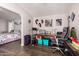 Charming bedroom with laminate floors, a desk, decor and a view to the next room with a bed at 201 S Greenfiled Rd -- # 199, Mesa, AZ 85206