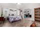 Bright bedroom featuring wood floors, a decorative bedspread, and an attached office space at 201 S Greenfiled Rd -- # 199, Mesa, AZ 85206