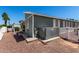 Exterior view of home showing siding, windows, patio, and manicured yard at 201 S Greenfiled Rd -- # 199, Mesa, AZ 85206