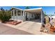 Charming home featuring a covered carport, front porch and beautiful landscaping at 201 S Greenfiled Rd -- # 199, Mesa, AZ 85206