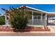 Charming home featuring a cozy front porch, carport, and beautiful landscaping at 201 S Greenfiled Rd -- # 199, Mesa, AZ 85206