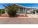 Charming home featuring a cozy front porch, carport, and beautiful landscaping at 201 S Greenfiled Rd -- # 199, Mesa, AZ 85206