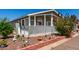 Charming front yard with a small porch, delightful garden decorations, and lovely landscaping at 201 S Greenfiled Rd -- # 199, Mesa, AZ 85206