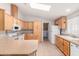 Functional kitchen with light wood cabinetry, ample counter space, and white appliances at 201 S Greenfiled Rd -- # 199, Mesa, AZ 85206