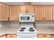 Kitchen featuring hardwood cabinetry, bright countertops, and a view of the kitchen appliances at 201 S Greenfiled Rd -- # 199, Mesa, AZ 85206