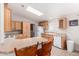 Kitchen featuring hardwood cabinetry, a skylight, bright counters, and nice appliances at 201 S Greenfiled Rd -- # 199, Mesa, AZ 85206