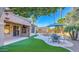 Outdoor living space with a covered patio, lush greenery, and a view of the inviting pool area at 2224 W Olive Way, Chandler, AZ 85248
