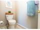 Powder room featuring a modern toilet, light gray walls, and decorative accents at 2224 W Olive Way, Chandler, AZ 85248