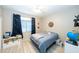 Bedroom with a blue bedspread, wood-look tile flooring, and white storage cabinet at 2224 W Olive Way, Chandler, AZ 85248