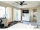 Main bedroom offers a sliding door to an outside view, a chest of drawers, and exercise equipment at 2224 W Olive Way, Chandler, AZ 85248