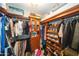 Walk-in closet features hanging racks, custom shelving, and space for organized storage at 2224 W Olive Way, Chandler, AZ 85248