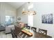 Elegant dining room featuring a modern chandelier and a spacious dark wood table with seating for six at 2224 W Olive Way, Chandler, AZ 85248