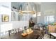 Elegant dining room with a large table, chandelier, and views into the living area at 2224 W Olive Way, Chandler, AZ 85248