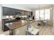 Modern kitchen features dark cabinetry, granite countertops, and a breakfast nook with natural light at 2224 W Olive Way, Chandler, AZ 85248