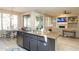 Open-concept kitchen with stainless steel appliances, granite counters, and breakfast bar overlooking the living area at 2224 W Olive Way, Chandler, AZ 85248