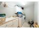 Convenient laundry room with washer, dryer, sink, and plenty of cabinet storage at 2224 W Olive Way, Chandler, AZ 85248