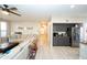 Open-concept floor plan shows living room with a fireplace and modern decor flowing into kitchen area at 2224 W Olive Way, Chandler, AZ 85248