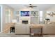 Cozy living room with a fireplace, built-in shelving, and a comfortable sectional sofa at 2224 W Olive Way, Chandler, AZ 85248