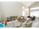 Open-concept living area with high ceilings, lots of natural light, and a dining area in the background at 2224 W Olive Way, Chandler, AZ 85248