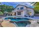 Backyard oasis with a sparkling pool, lush landscaping, and a covered patio perfect for outdoor entertaining at 2224 W Olive Way, Chandler, AZ 85248