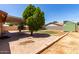 Home featuring a covered patio, desert landscaping, a storage shed, and a large stone paver patio area at 2302 E Monte Cristo Ave, Phoenix, AZ 85022