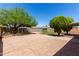 Spacious backyard offering a storage shed, desert landscaping, and a mix of gravel and concrete surfaces at 2302 E Monte Cristo Ave, Phoenix, AZ 85022