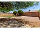 Property featuring a spacious backyard with desert landscaping, a block wall, and mature trees at 2302 E Monte Cristo Ave, Phoenix, AZ 85022