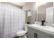Well lit bathroom featuring a shower/tub combo, updated vanity with gray cabinets, and a neutral color palette at 2302 E Monte Cristo Ave, Phoenix, AZ 85022
