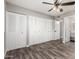 Bedroom featuring wood-look floors, a ceiling fan, closet doors, and attached bathroom at 2302 E Monte Cristo Ave, Phoenix, AZ 85022