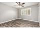Bedroom featuring wood-look floors, a ceiling fan, and window shutters at 2302 E Monte Cristo Ave, Phoenix, AZ 85022